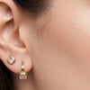 Moonstone stud styled in a second lobe piercing alongside a gold gemstone drop hoop