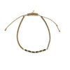 SABLE bracelet with faceted black spinel and 9k solid gold beads on braided taupe thread, showing the adjustable macramé closure.”